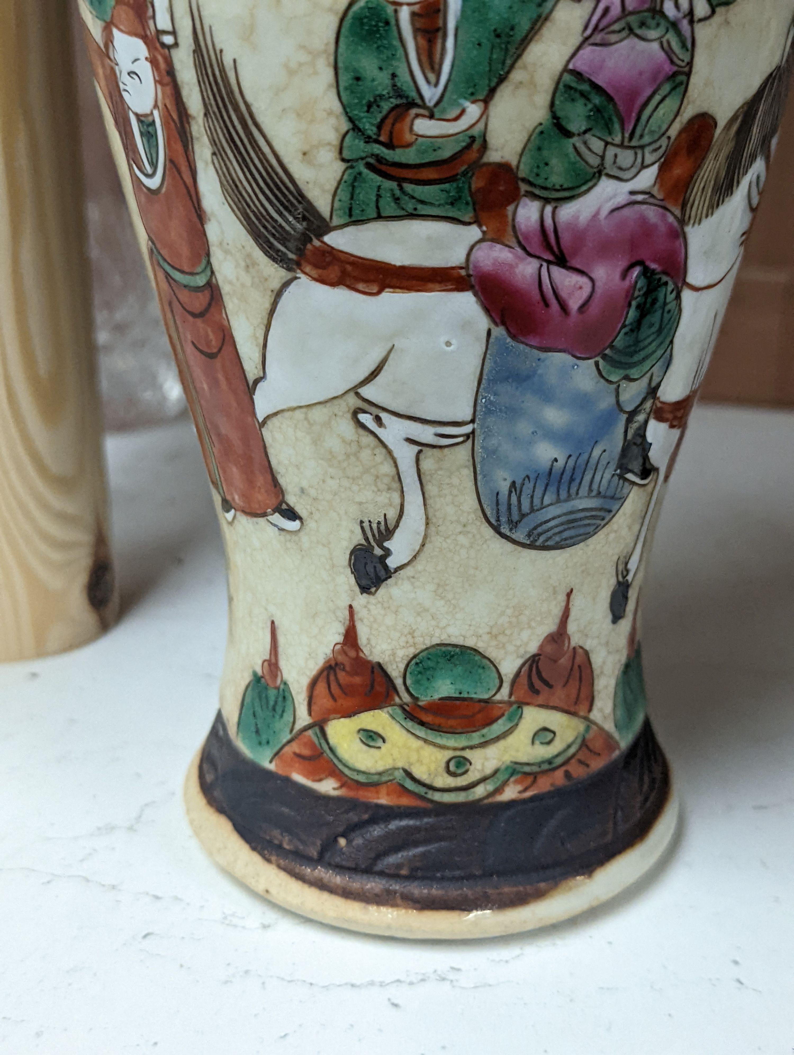 A pair of Chinese famille rose crackle glaze baluster jars and covers, 27cm.